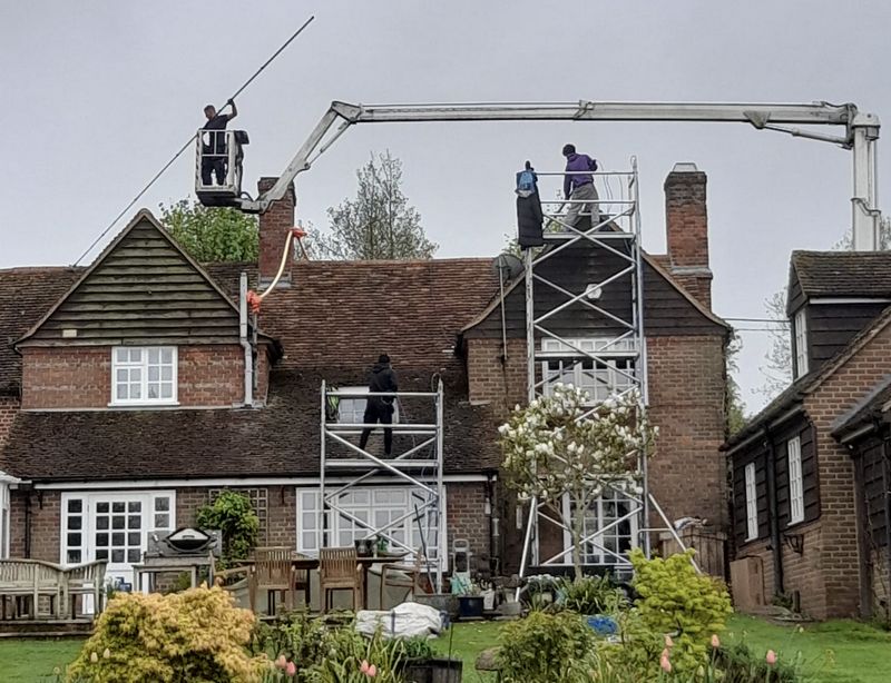 The Roof Moss Cleaners using cherry picker and scaffolding to clean roof safely and professionally in Romsey, Hampshire